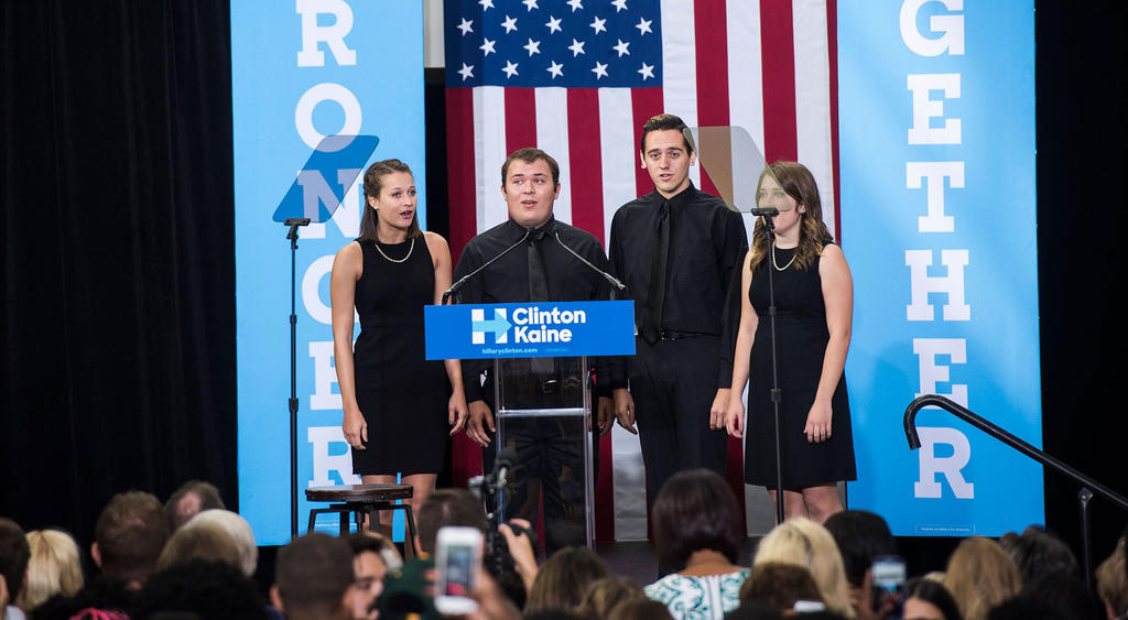 Music students Sophie, Byran, Dylan and Sophie welcome Michelle Obama during her visit to Mason, a close neighbor just to the south of the capital.